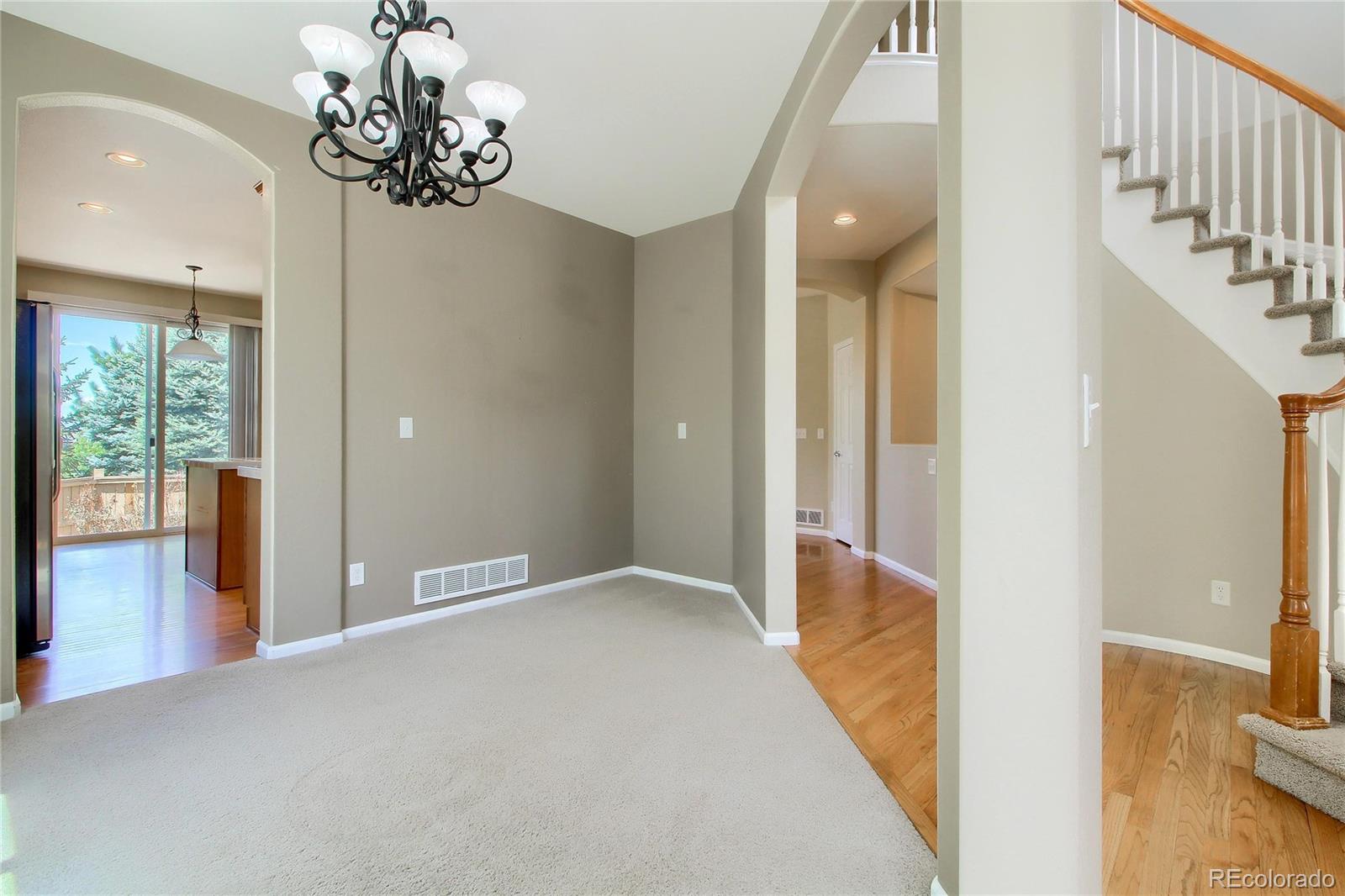 2705 Middlebury Drive Highlands Ranch, CO 80126 - Photo 13 of 40 a view of a hallway view with wooden floor and chandelier