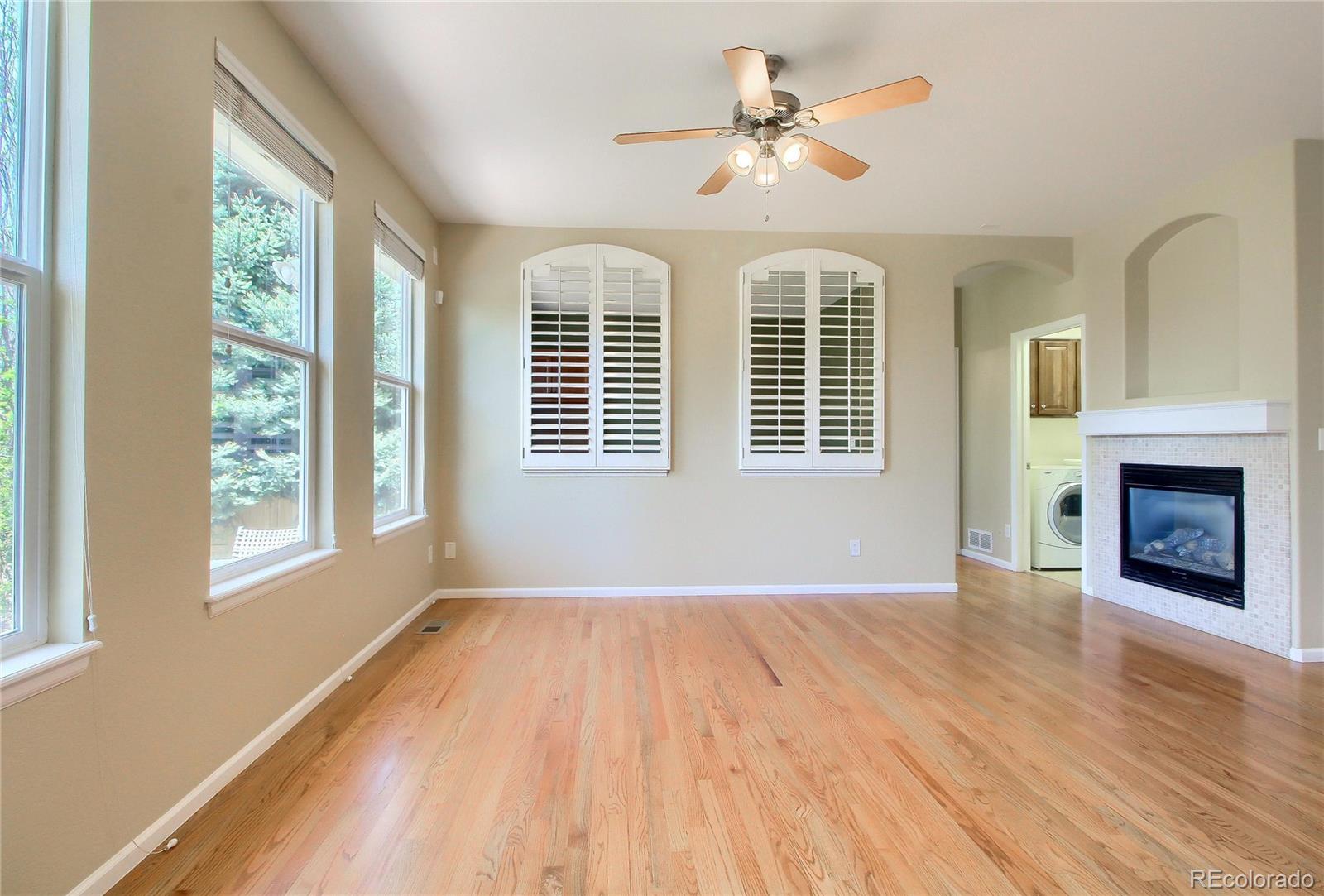 2705 Middlebury Drive Highlands Ranch, CO 80126 - Photo 15 of 40 a view of an empty room with a window and wooden floor