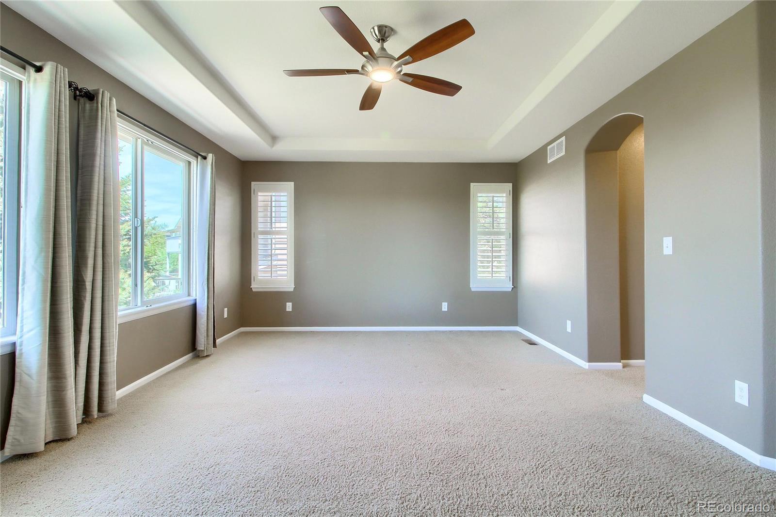 2705 Middlebury Drive Highlands Ranch, CO 80126 - Photo 19 of 40 an empty room with windows and ceiling fan