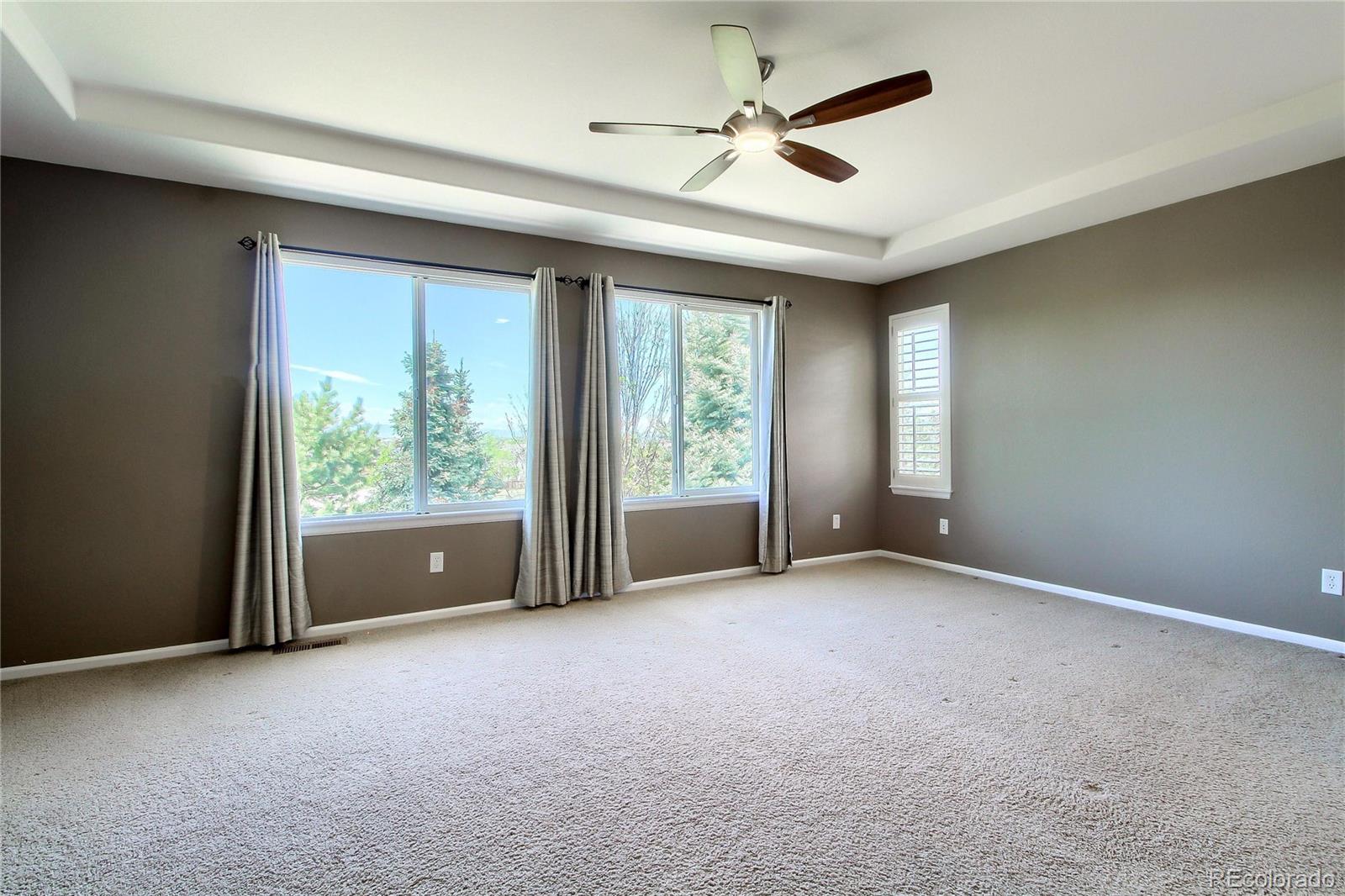 2705 Middlebury Drive Highlands Ranch, CO 80126 - Photo 20 of 40 an empty room with windows and ceiling fan