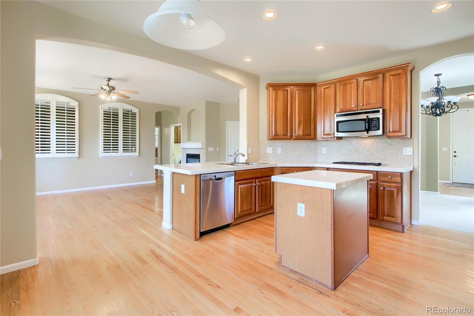 2705 Middlebury Drive Highlands Ranch, CO 80126 - Photo 2 of 40 a kitchen with stainless steel appliances granite countertop a stove and a sink