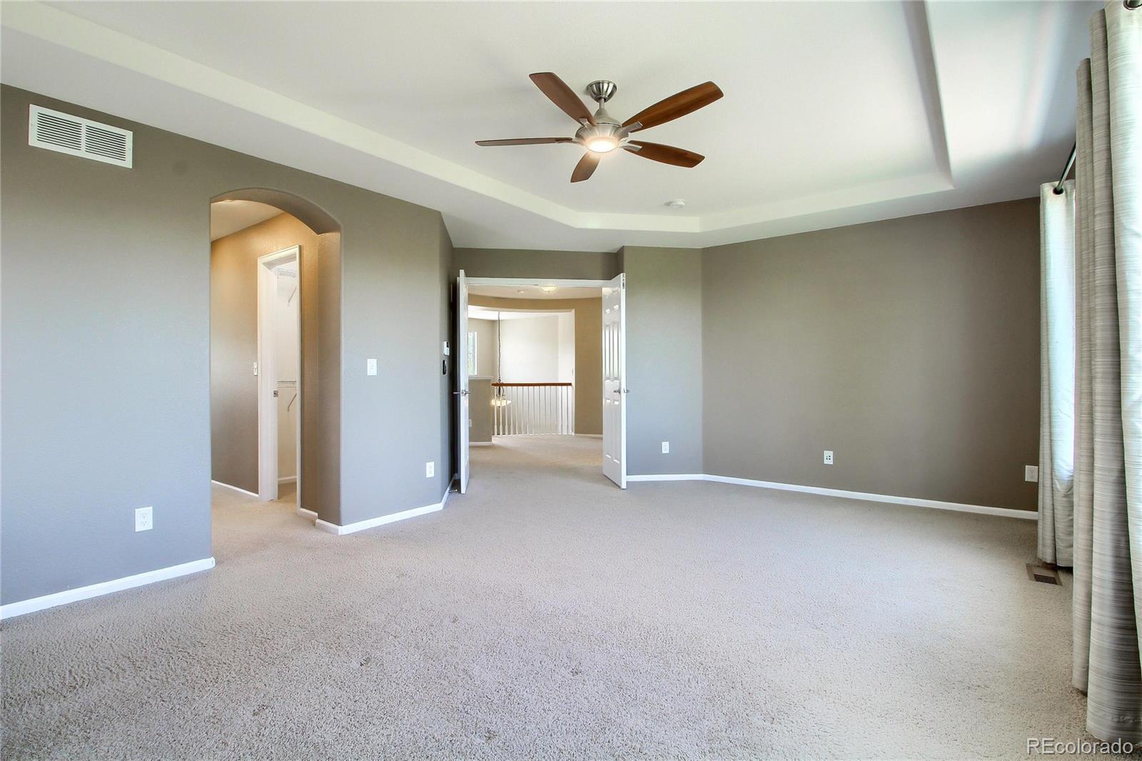 2705 Middlebury Drive Highlands Ranch, CO 80126 - Photo 21 of 40 an empty room that has a window and a ceiling fan