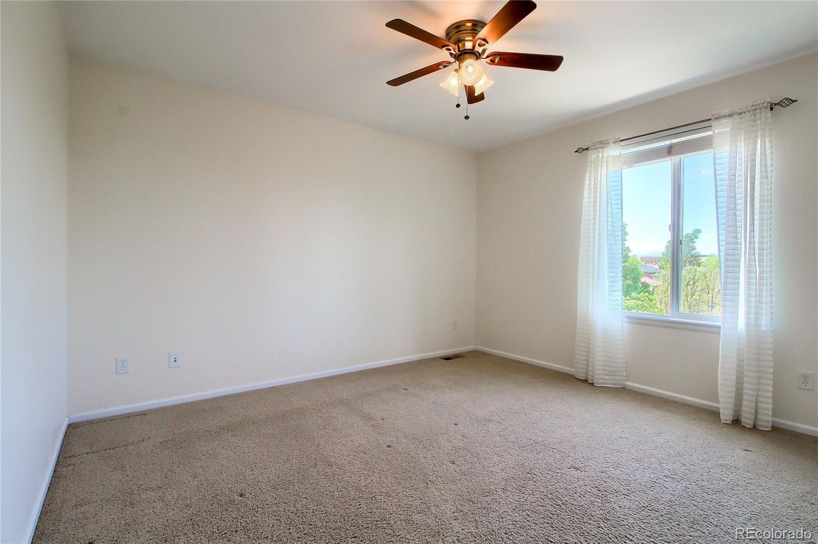 2705 Middlebury Drive Highlands Ranch, CO 80126 - Photo 24 of 40 an empty room with a window and a fan