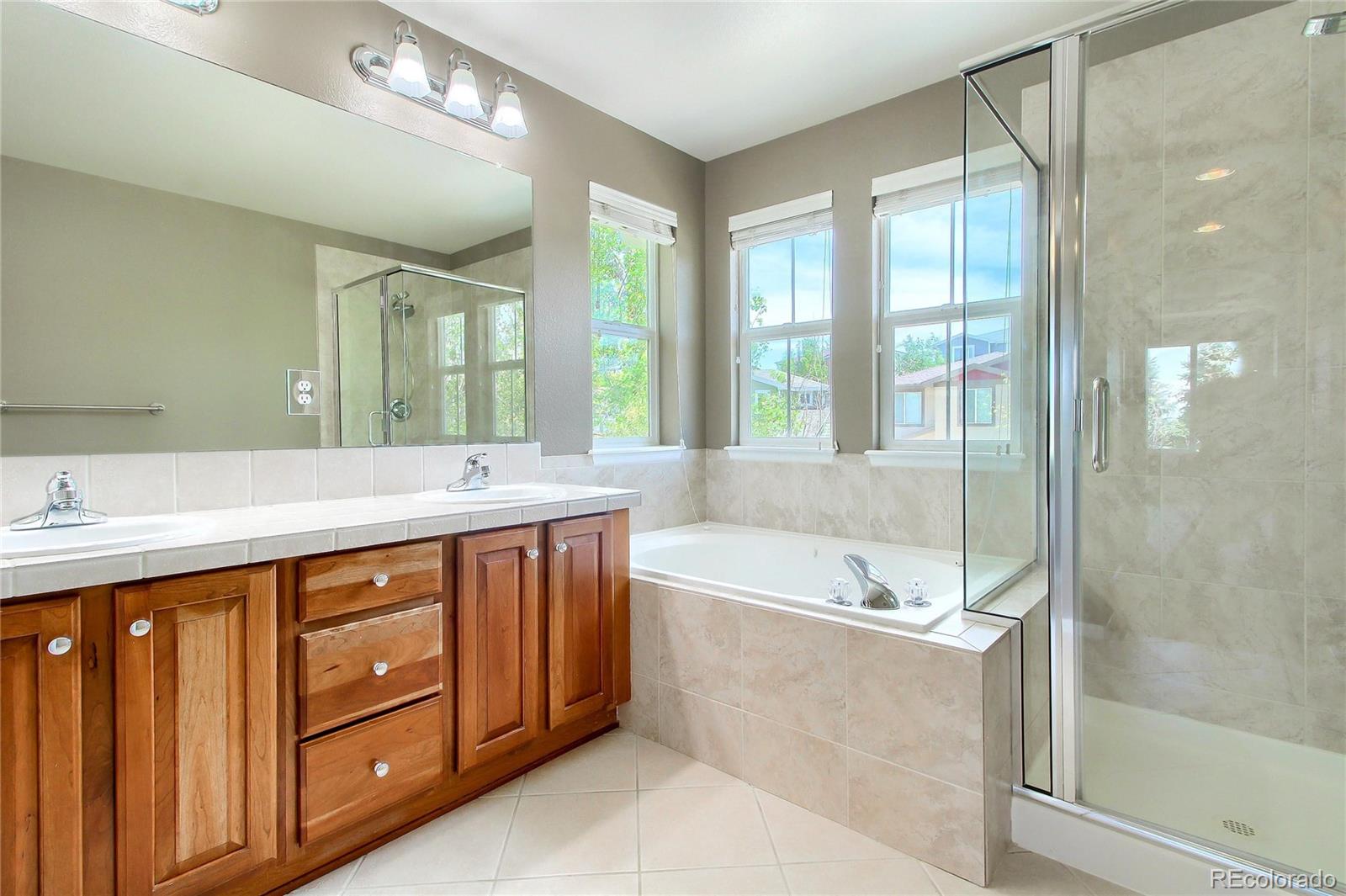2705 Middlebury Drive Highlands Ranch, CO 80126 - Photo 29 of 40 a spacious bathroom with a tub sink shower and mirror