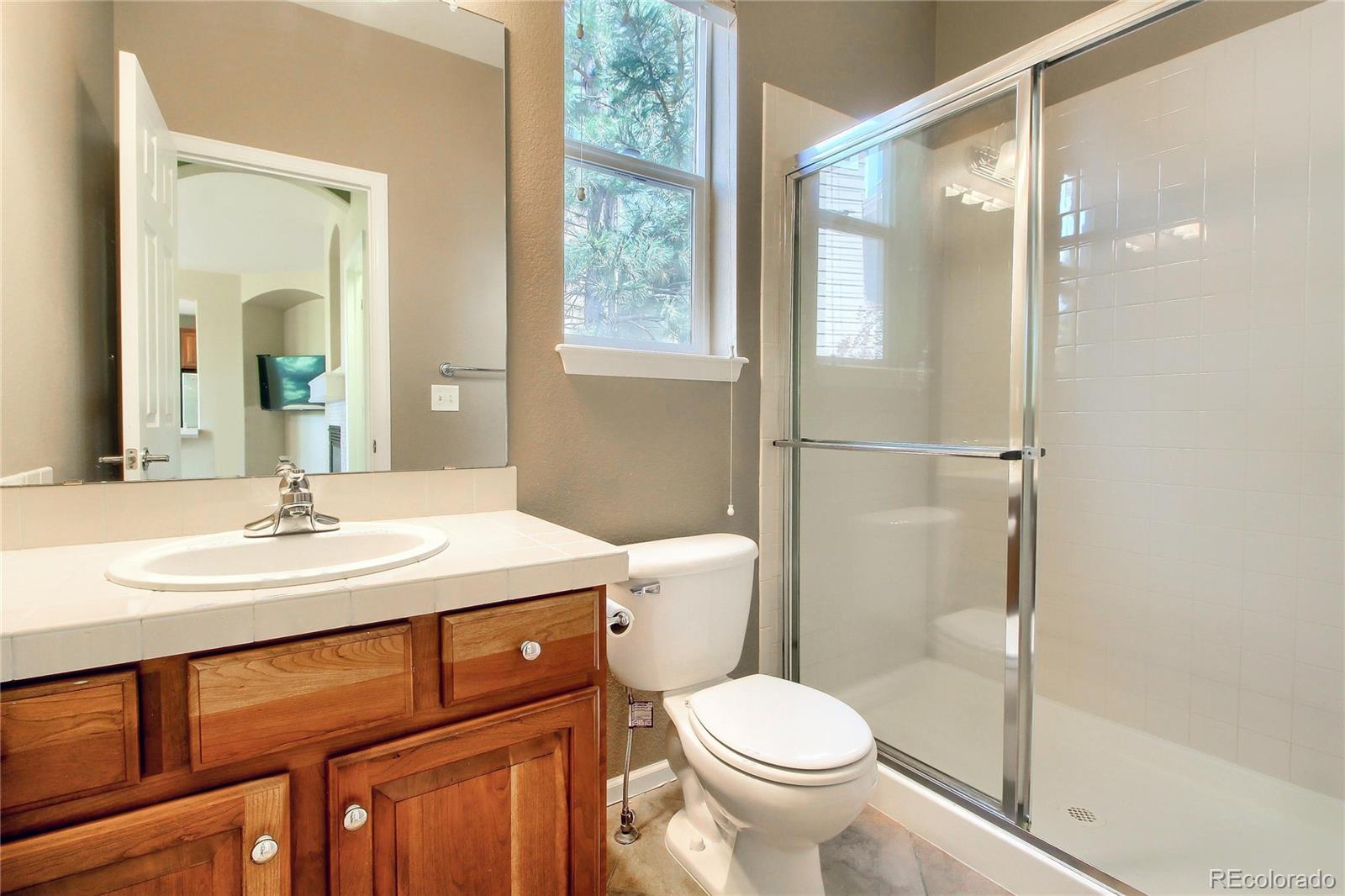 2705 Middlebury Drive Highlands Ranch, CO 80126 - Photo 30 of 40 a bathroom with a sink toilet and shower