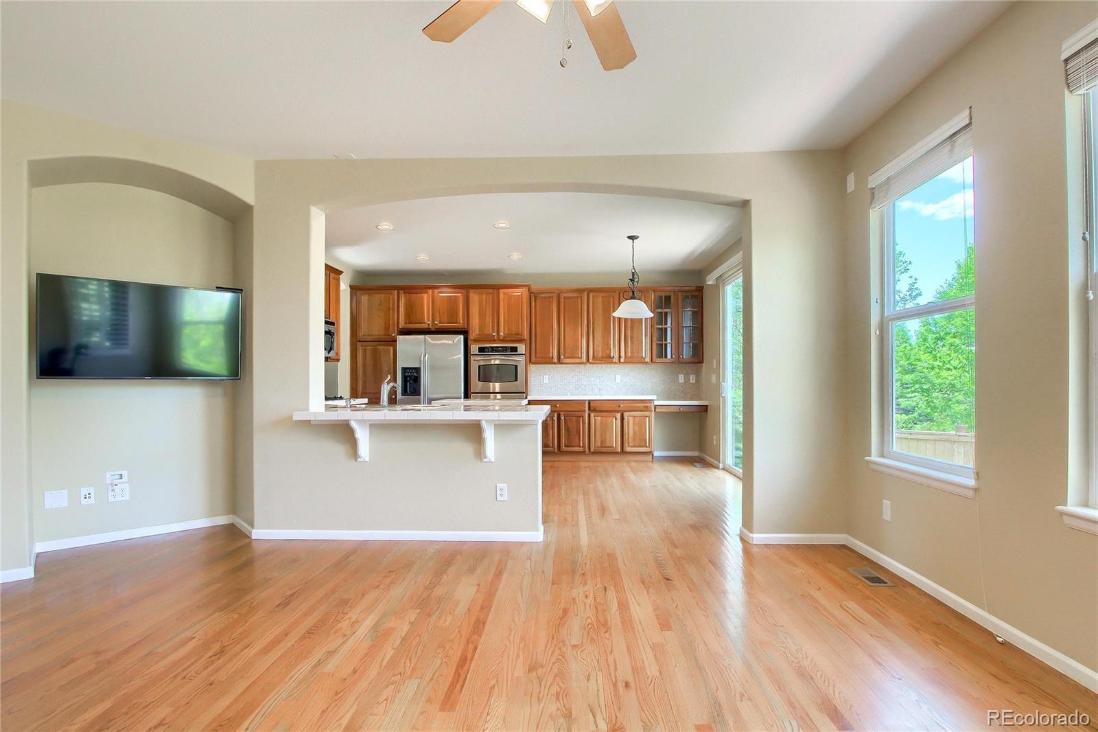 2705 Middlebury Drive Highlands Ranch, CO 80126 - Photo 4 of 40 a view of a living room and kitchen with wooden floor