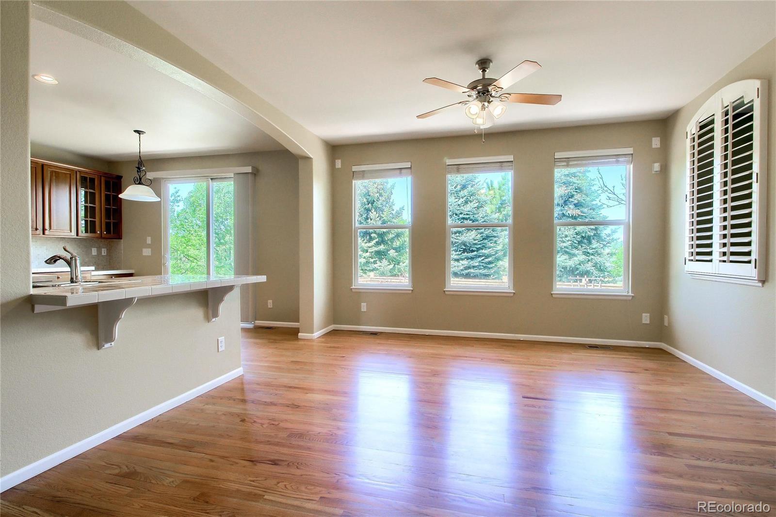 2705 Middlebury Drive Highlands Ranch, CO 80126 - Photo 7 of 40 a view of a kitchen with wooden floor and a window