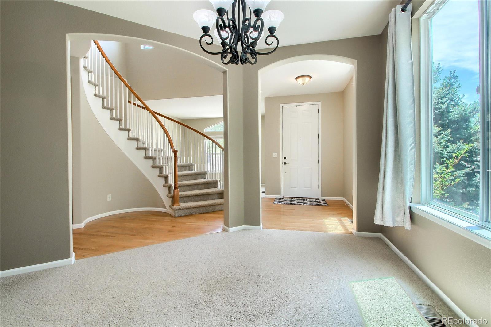 2705 Middlebury Drive Highlands Ranch, CO 80126 - Photo 8 of 40 a view of entryway with stairs and wooden floor