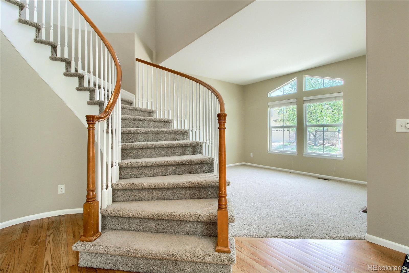 2705 Middlebury Drive Highlands Ranch, CO 80126 - Photo 9 of 40 a view of staircase with wooden floor and a potted plant