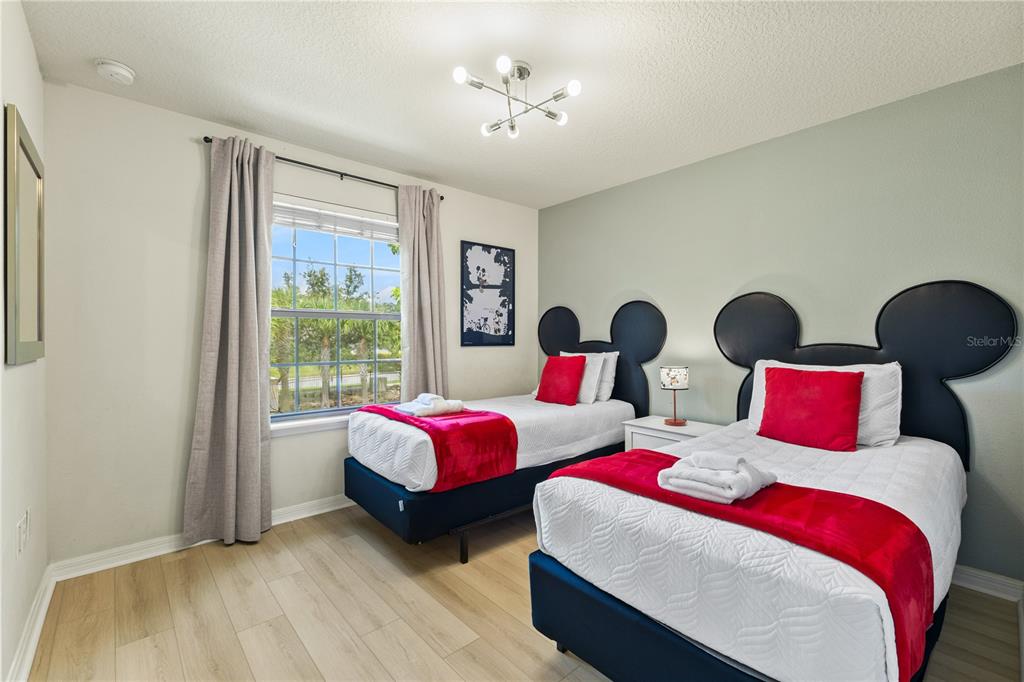 1905 Majorca Drive Kissimmee, FL 34747 - Photo 13 of 59 a bedroom with two beds and a large window