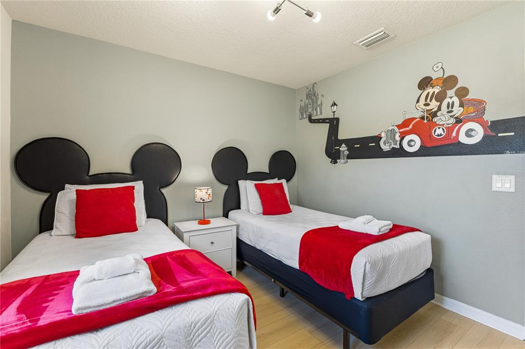 1905 Majorca Drive Kissimmee, FL 34747 - Photo 15 of 59 a bedroom with two beds and painting on the wall