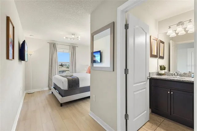 a bedroom with a bed and a painting on the wall