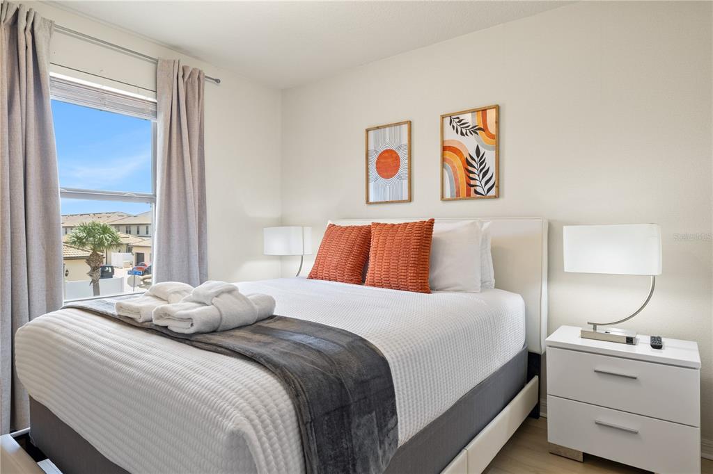 1905 Majorca Drive Kissimmee, FL 34747 - Photo 17 of 59 a bedroom with a bed and a lamp on dresser next to a window