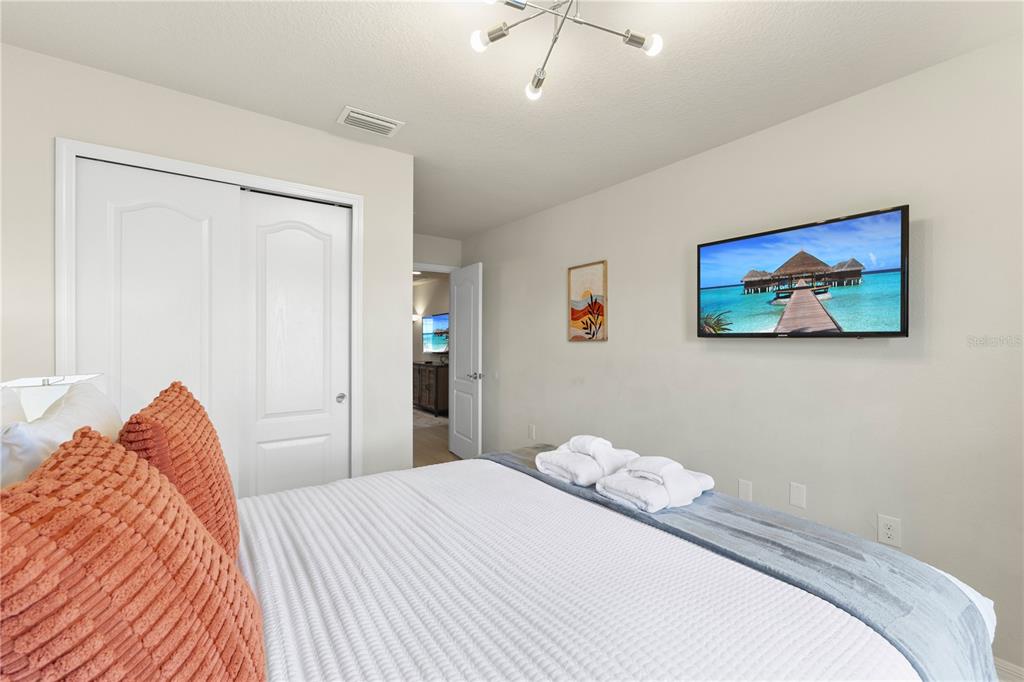 1905 Majorca Drive Kissimmee, FL 34747 - Photo 18 of 59 a bedroom with a bed and a painting on the wall