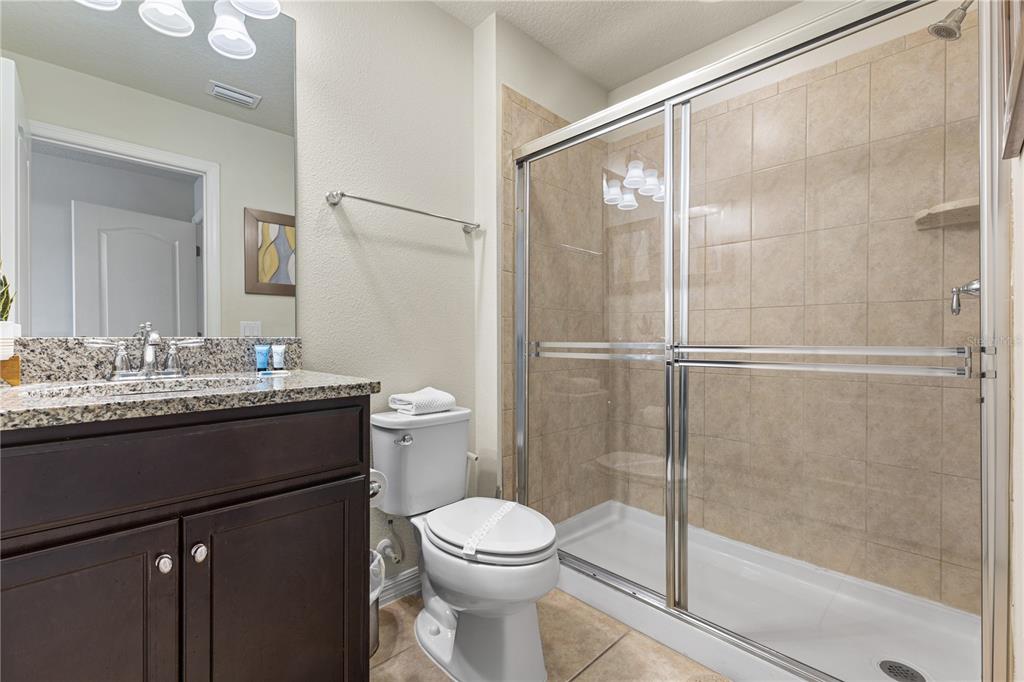 1905 Majorca Drive Kissimmee, FL 34747 - Photo 19 of 59 a bathroom with a granite countertop sink toilet and shower