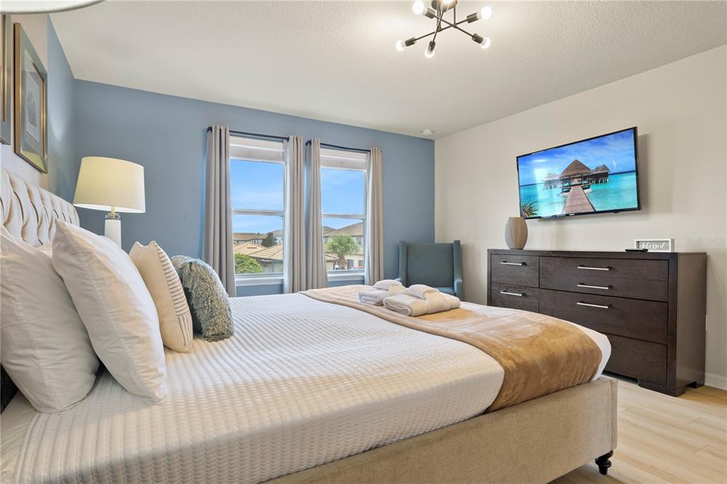 1905 Majorca Drive Kissimmee, FL 34747 - Photo 22 of 59 a bedroom with a bed and a painting on the wall