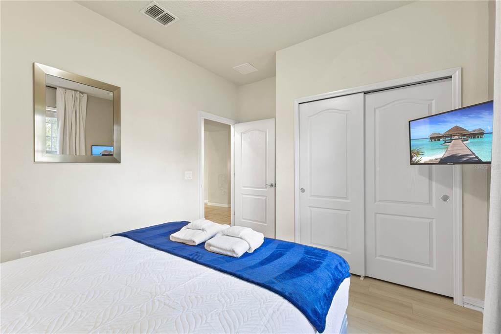 1905 Majorca Drive Kissimmee, FL 34747 - Photo 37 of 59 a bedroom with a bed and a painting on the wall