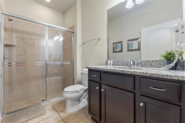 a living room kitchen with a couch and a view of kitchen