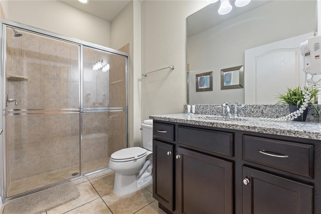 1905 Majorca Drive Kissimmee, FL 34747 - Photo 38 of 59 a bathroom with a granite countertop sink toilet and shower