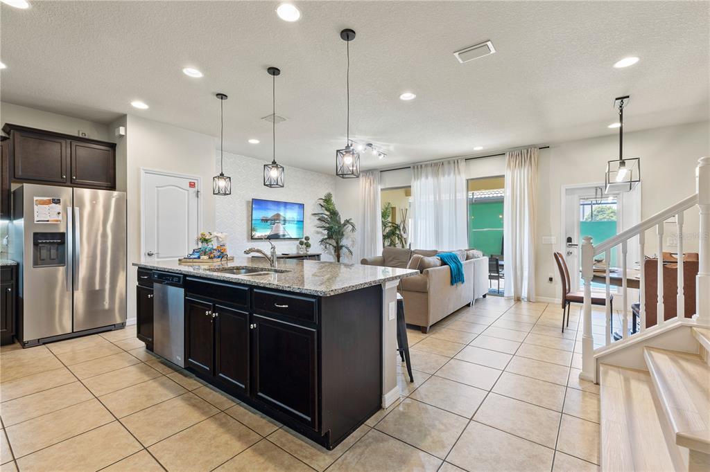 1905 Majorca Drive Kissimmee, FL 34747 - Photo 39 of 59 a kitchen with stainless steel appliances granite countertop a sink and a refrigerator