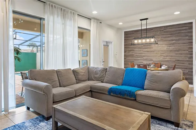 a view of a livingroom with wooden floor and stairs