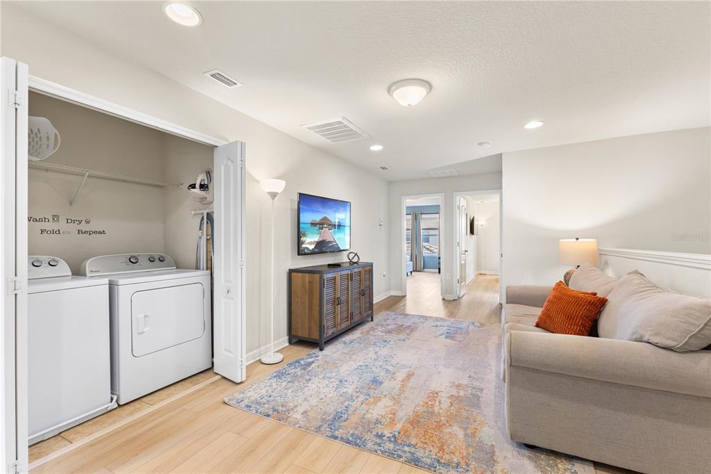 1905 Majorca Drive Kissimmee, FL 34747 - Photo 50 of 59 a living room with furniture a kitchen view and a refrigerator