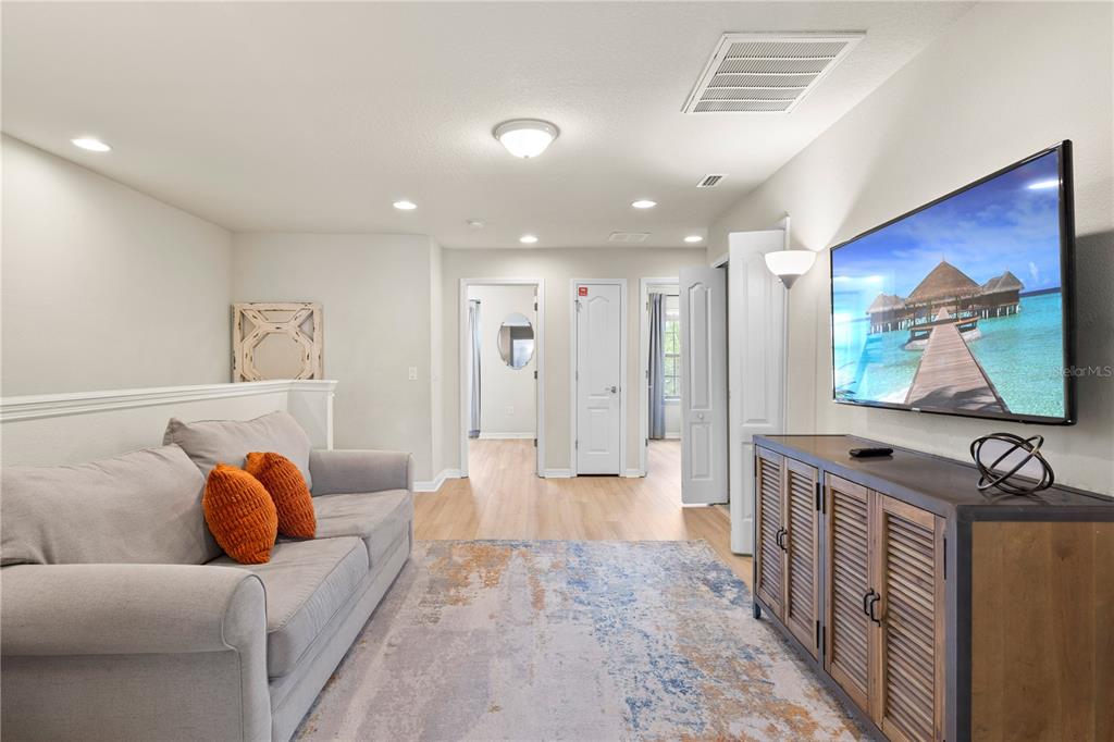 1905 Majorca Drive Kissimmee, FL 34747 - Photo 52 of 59 a living room with furniture and a flat screen tv