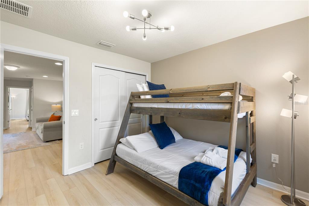 1905 Majorca Drive Kissimmee, FL 34747 - Photo 56 of 59 a bedroom with a bed and a chandelier