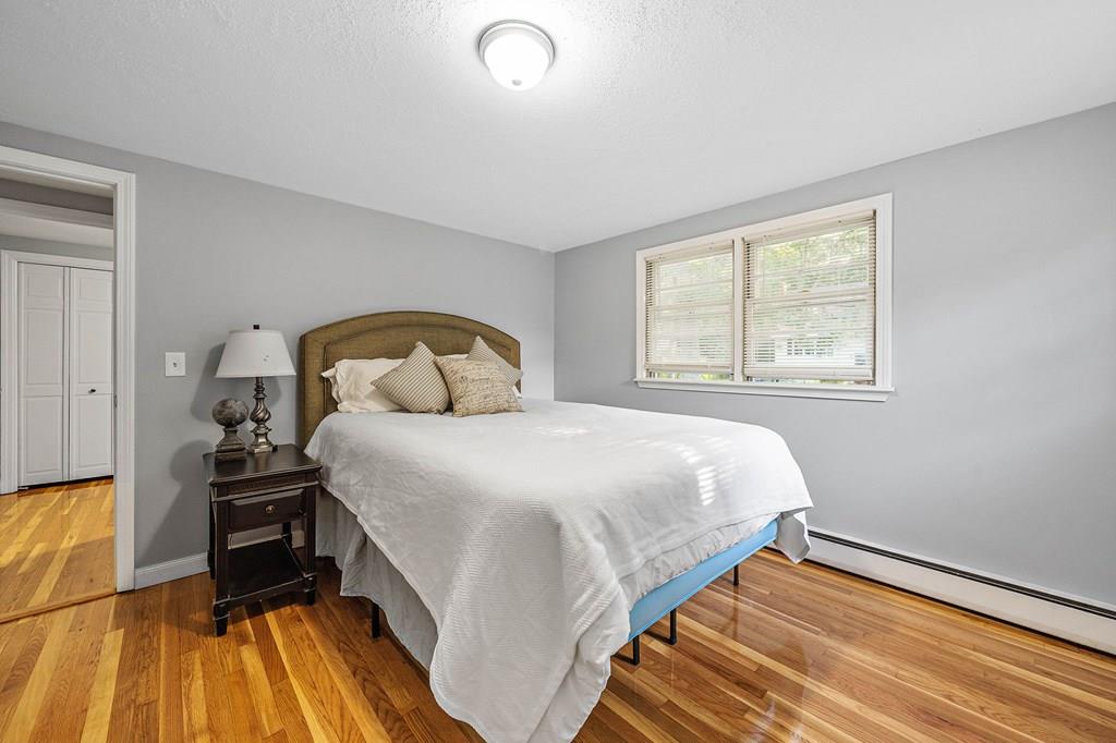 1075 Glebe Street Taunton, MA 02780 - Photo 12 of 31 a bedroom with a bed and wooden floor