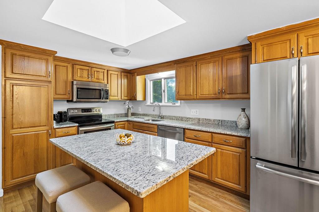 1075 Glebe Street Taunton, MA 02780 - Photo 4 of 31 a kitchen with stainless steel appliances granite countertop a refrigerator stove microwave and sink