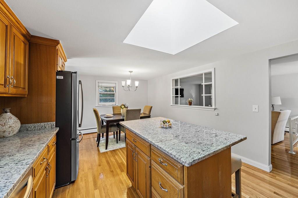 1075 Glebe Street Taunton, MA 02780 - Photo 5 of 31 a kitchen with a stove a refrigerator and dining table