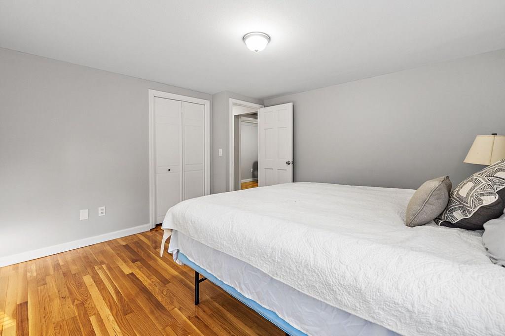1075 Glebe Street Taunton, MA 02780 - Photo 10 of 31 a bedroom with a bed and a wooden floor