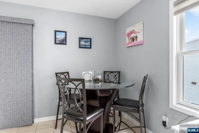 a view of a dining room with furniture and a window
