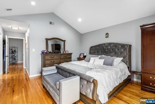a bedroom with a bed and a view of kitchen