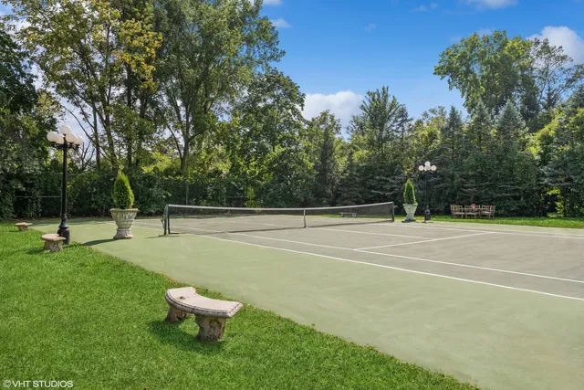 a spacious bathroom with a granite countertop sink a mirror and shower