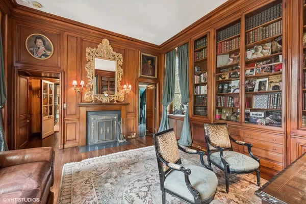 a living room with furniture a flat screen tv and a floor to ceiling window