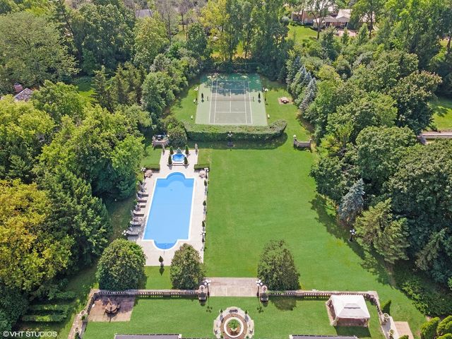 an aerial view of a house with a garden and swimming pool