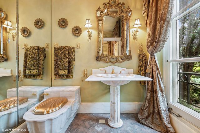 a front view of a house with garden and sitting area