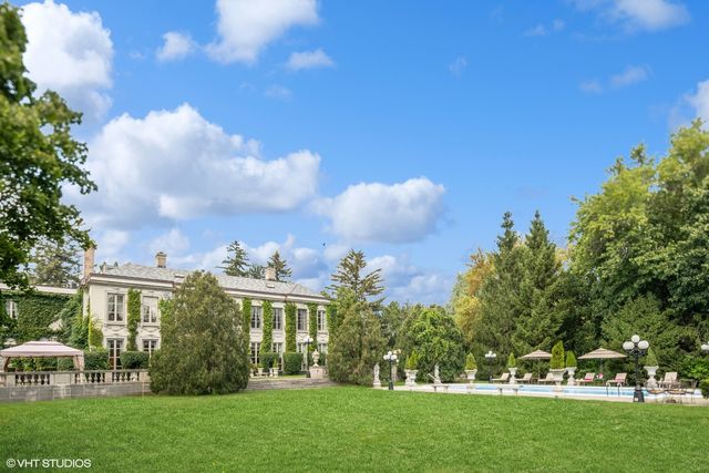 a view of a building with a swimming pool and sitting area