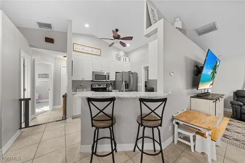 a view of a dining room with furniture and a chandelier