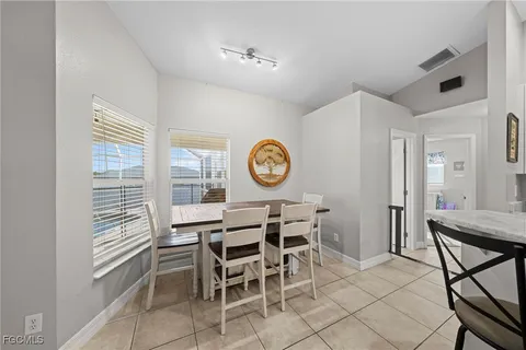 a dining room with furniture and a window