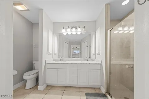 a spacious bathroom with a toilet sink and mirror