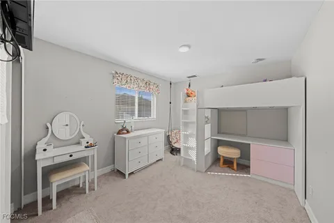 a room with furniture a flat tv screen and a dresser