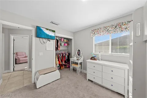 a bedroom with furniture and a window