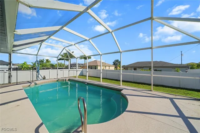 a view of a backyard with swimming pool