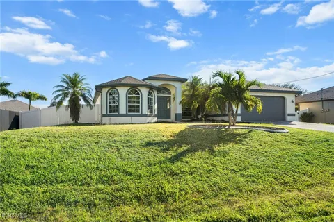a view of a house with a large window and a yard