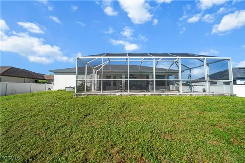 a view of a house with a backyard