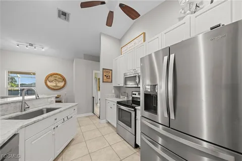 a kitchen with stainless steel appliances granite countertop a refrigerator and a sink
