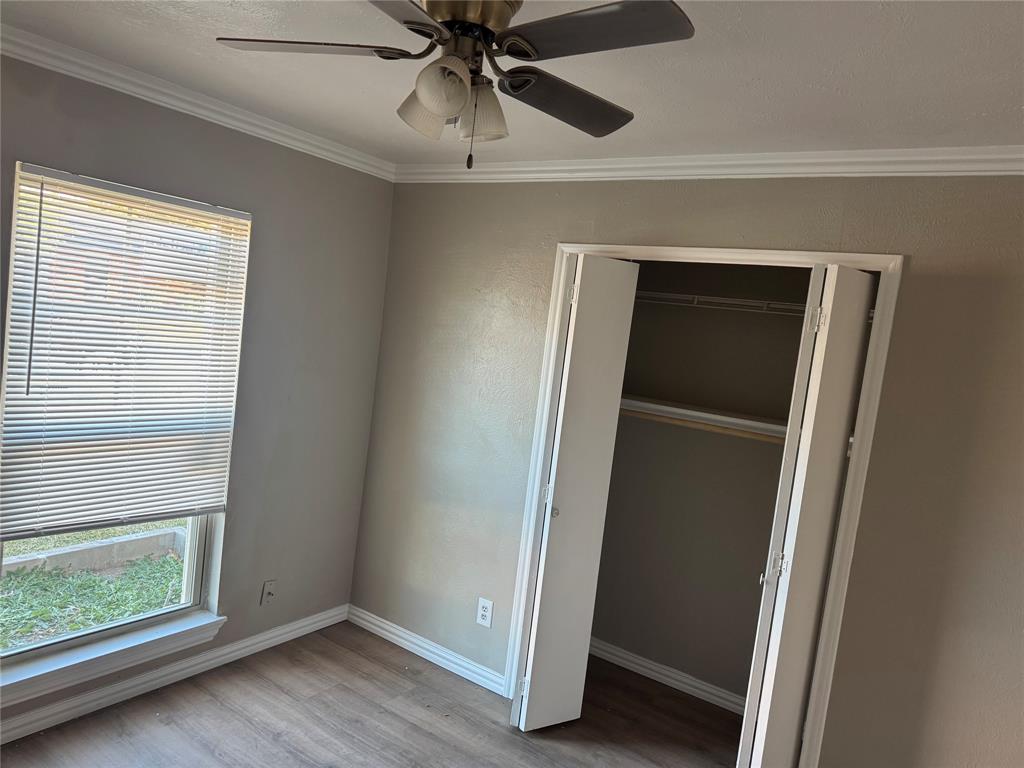 2125 Kings Road Carrollton, TX 75007 - Photo 13 of 33 a view of an empty room with a window and wooden floor