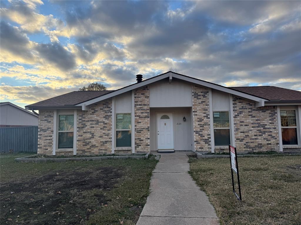 2125 Kings Road Carrollton, TX 75007 - Photo 2 of 33 a front view of a house with garden